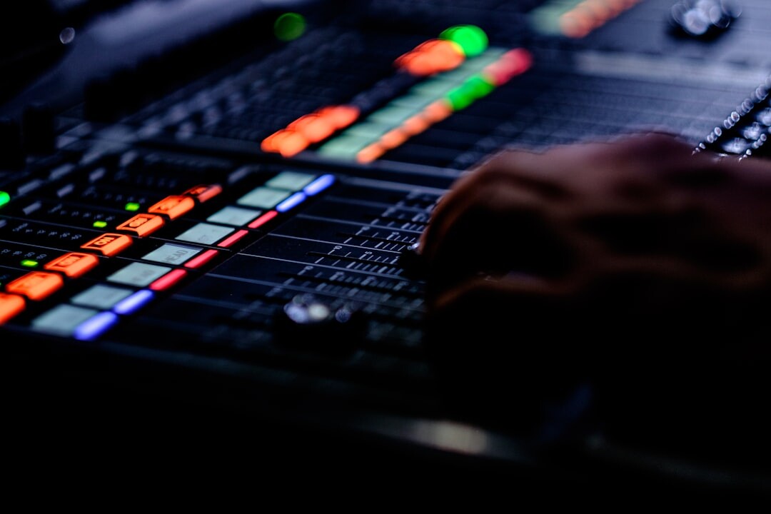 Audio engineer adjusting a sound mixing console