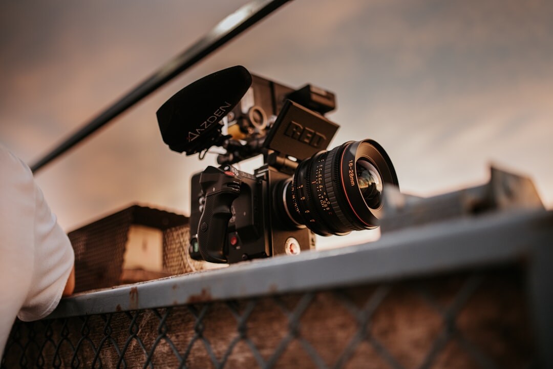 Camera operator filming with a professional broadcast camera